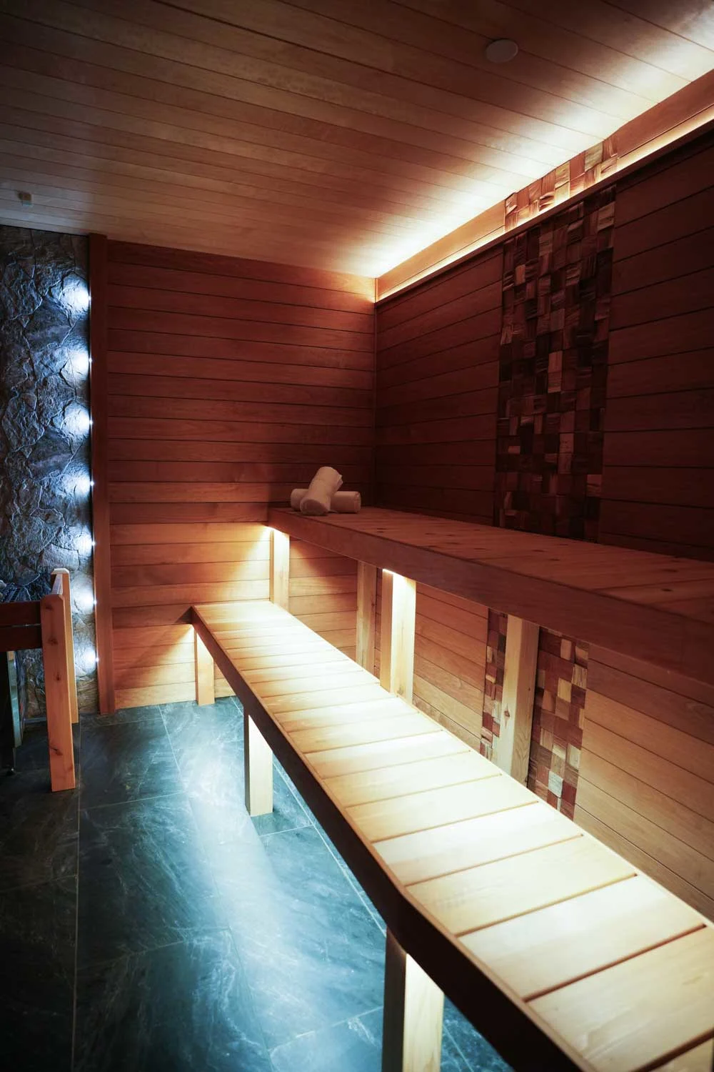 Traditional wood banya-style sauna interior with natural timber benches at Fusion Spa & Resort.
