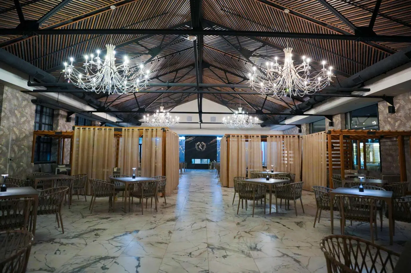 Fusion Spa & Resort Restaurant dining hall with chandeliers and upscale resort ambiance.