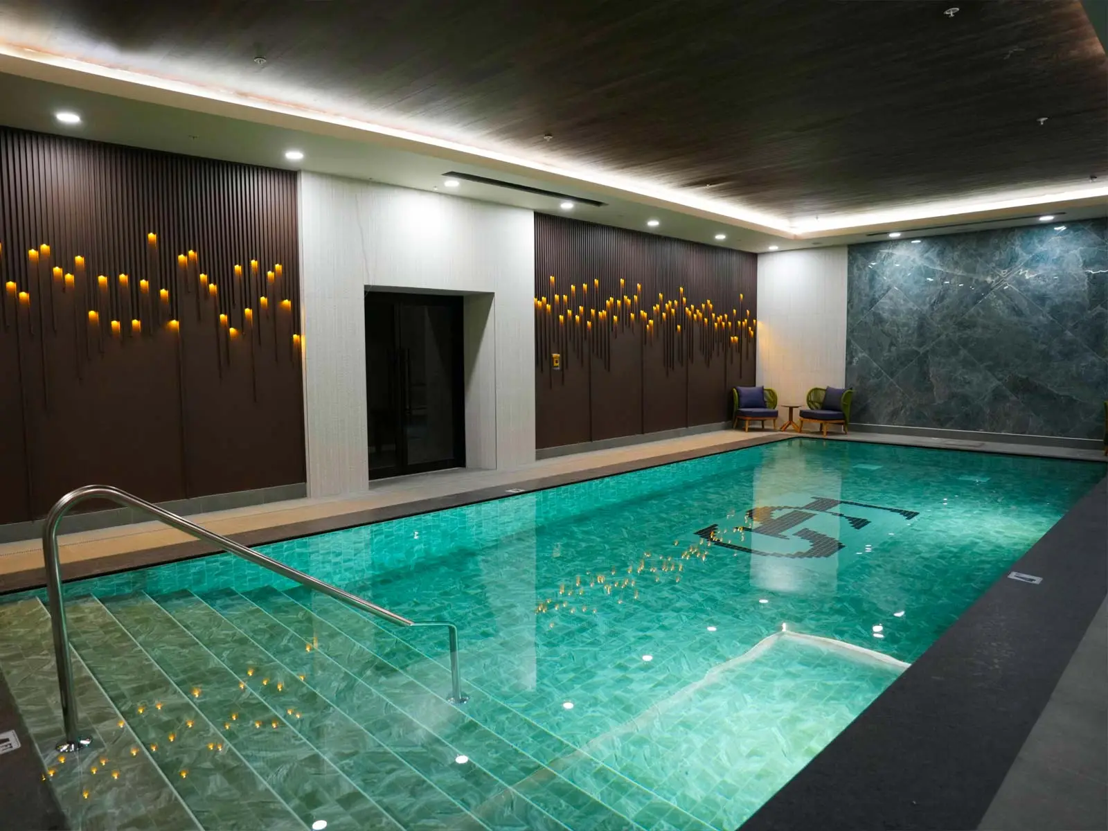 All-season indoor main pool with serene lighting and luxury spa atmosphere at Fusion Spa & Resort.