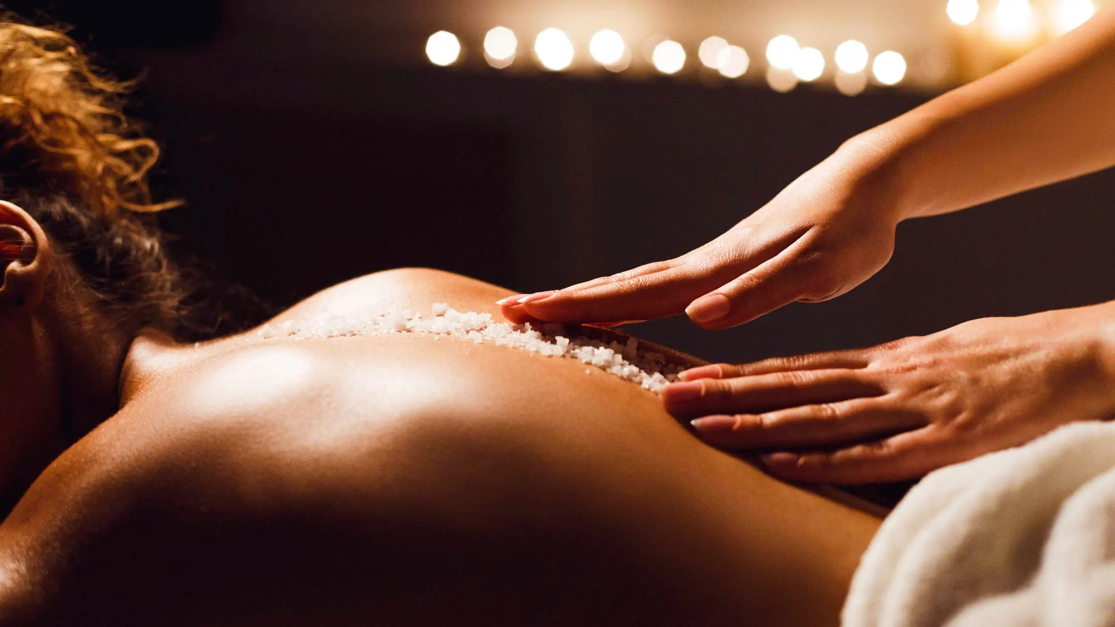 Luxury body scrub treatment at Fusion Spa & Resort featuring a calming exfoliation ritual in a serene spa setting.