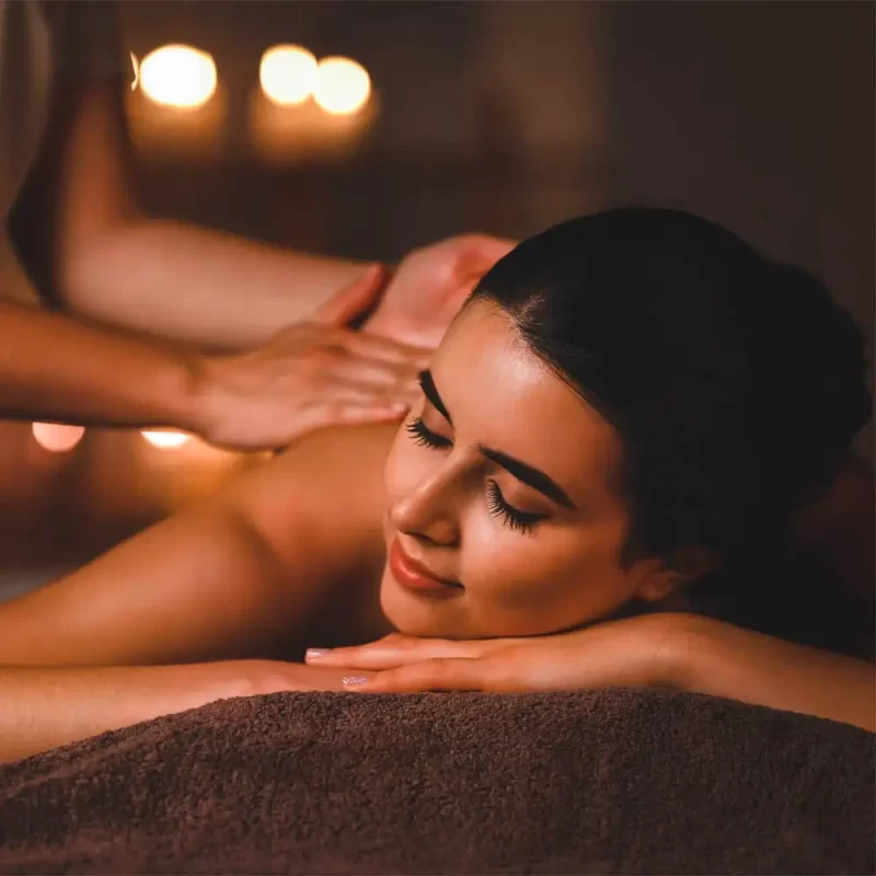 Relaxing massage therapy at Fusion Spa & Resort featuring a calming touch in a softly lit, tranquil spa setting.