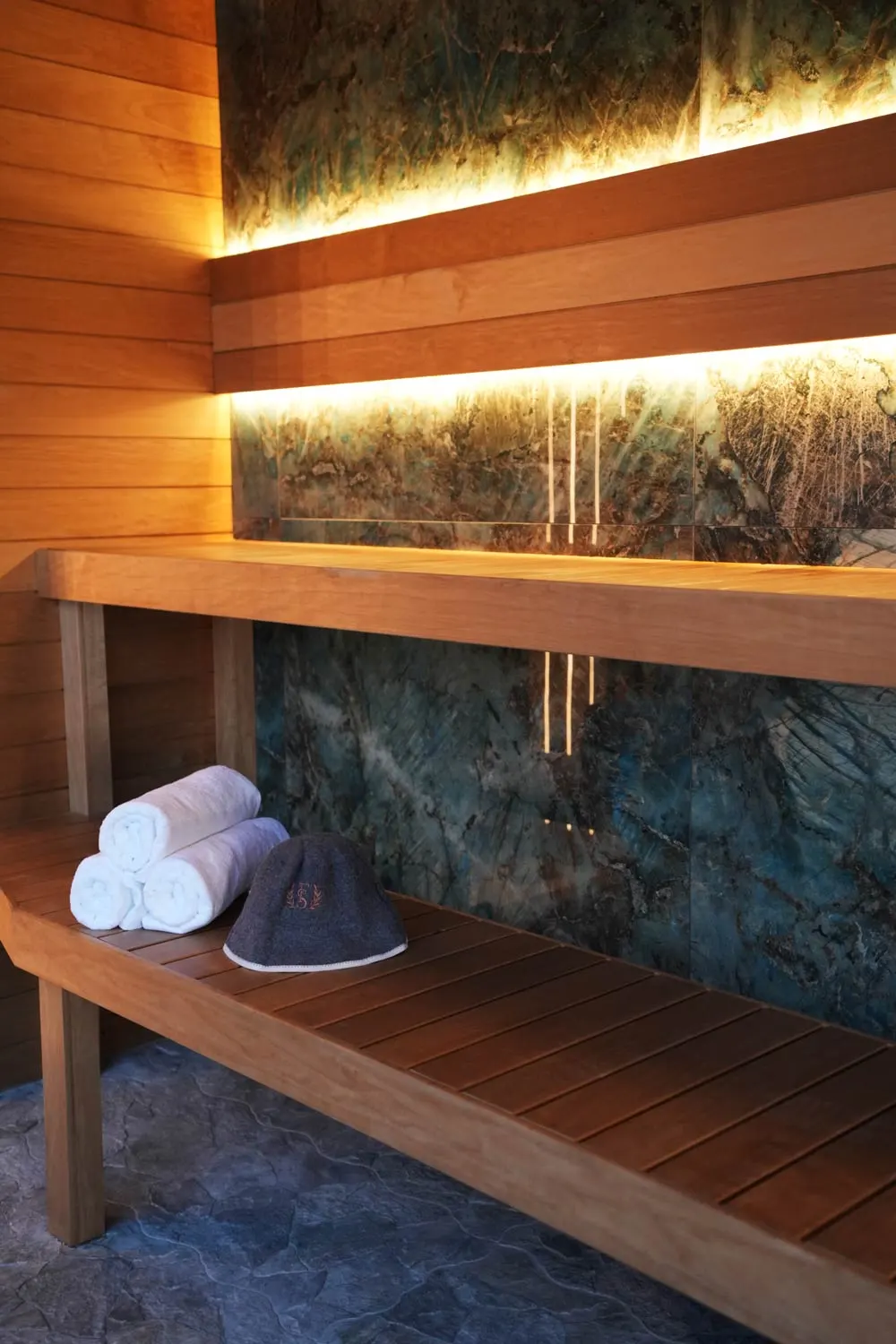 Panoramic dry Finnish sauna with wooden benches at Fusion Spa & Resort.