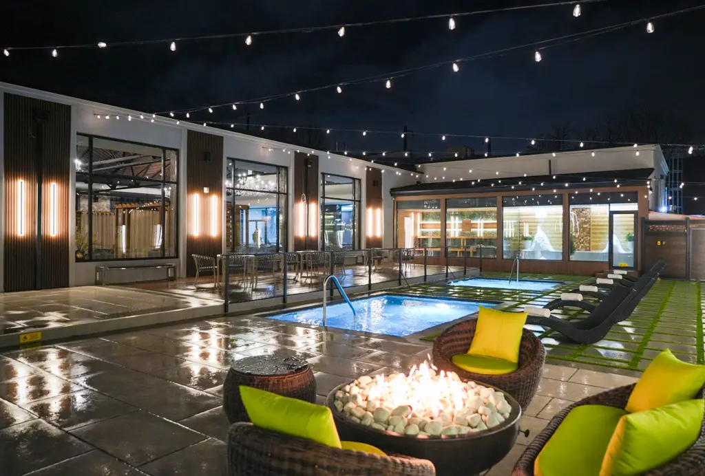Outdoor Thermal Pools at Night Outdoor thermal pools, fire pit seating, and relaxation loungers at Fusion Spa & Resort